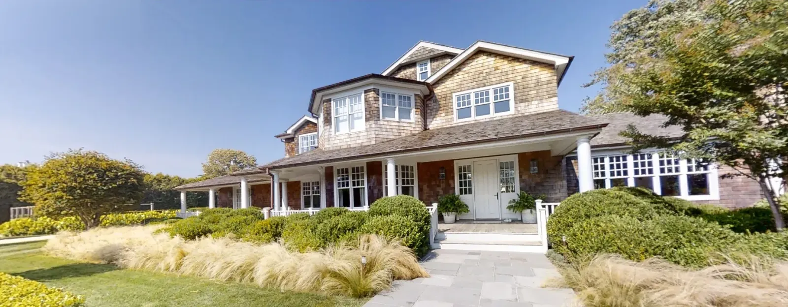 Matterport walkthrough view of a scanned shingle-style home with a wraparound porch